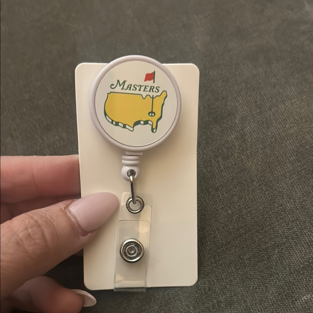 Masters White and Yellow Retractable Badge Reel with Red Flag Logo
